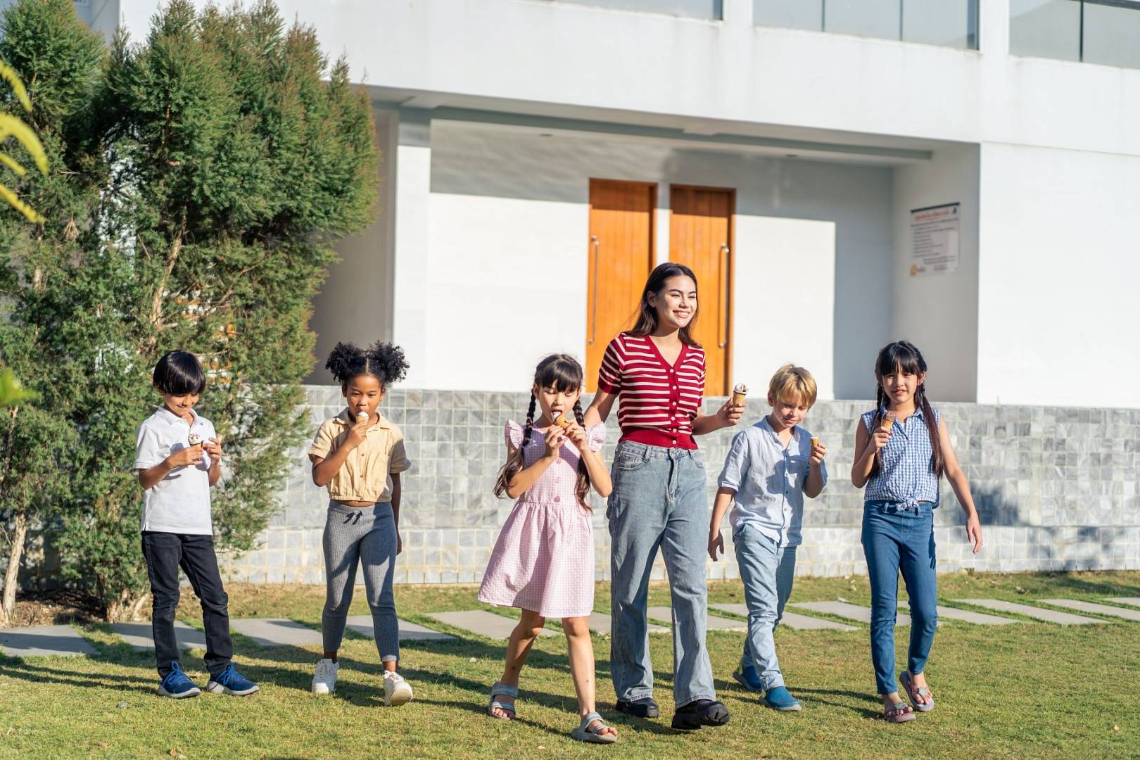 group-of-children-eating-an-ice-cream-with-teacher-2025-03-25-07-56-05-utc_wp